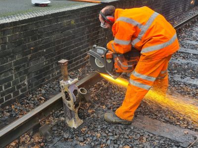 Cutting the worn rail into 30 foot lengths for re-use off site