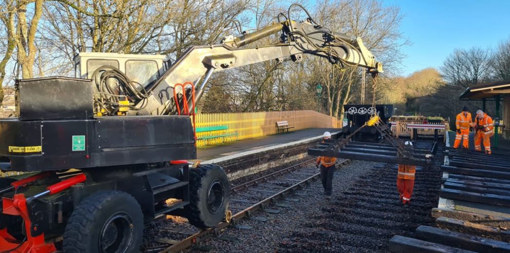 Old sleepers being placed on the platform to allow the chairs to be removed